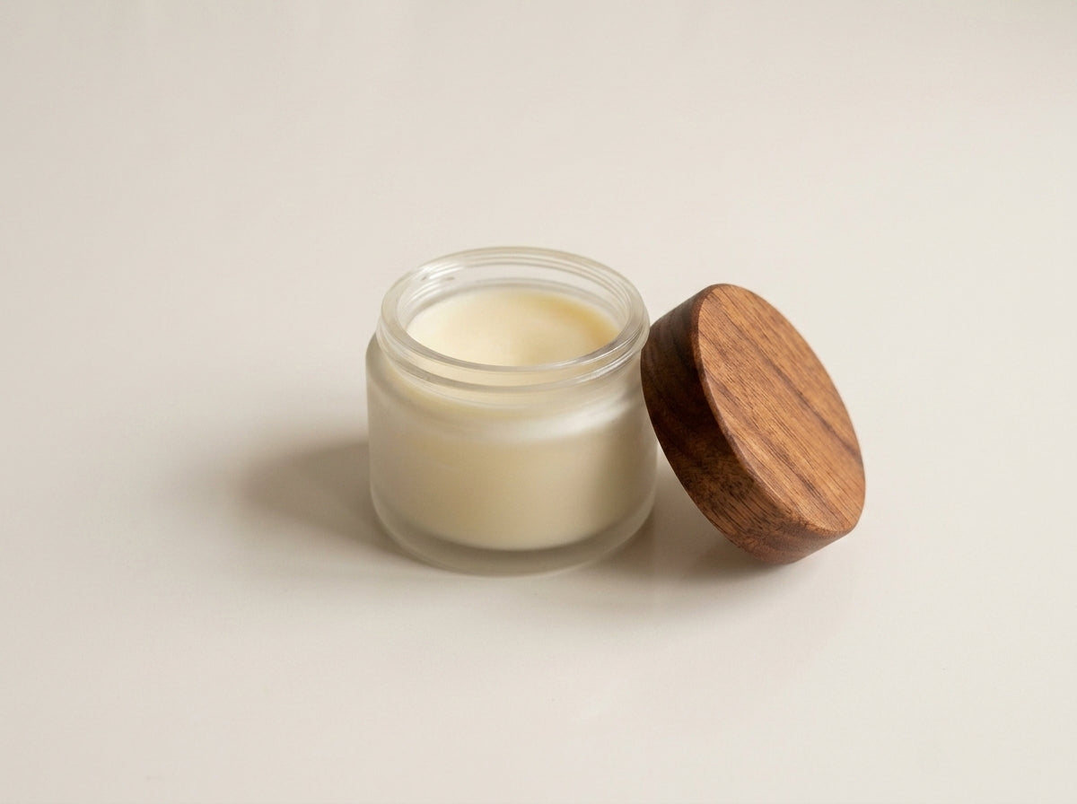Creamy organic MCT and beeswax wood butter paste inside glass jar
