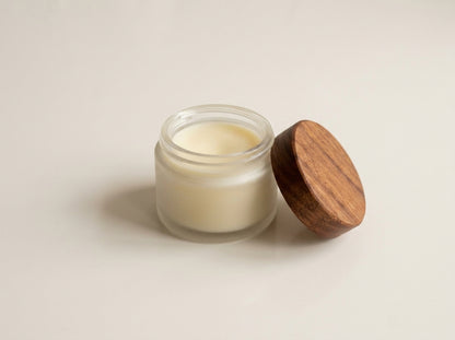 Creamy organic MCT and beeswax wood butter paste inside glass jar