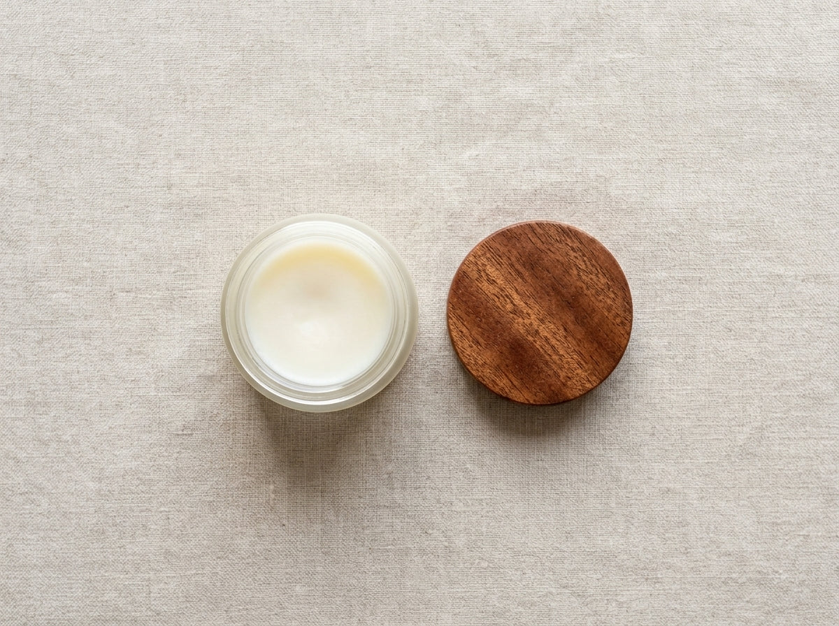 Top-down view of open Board Butter jar and round Sapele wood lid