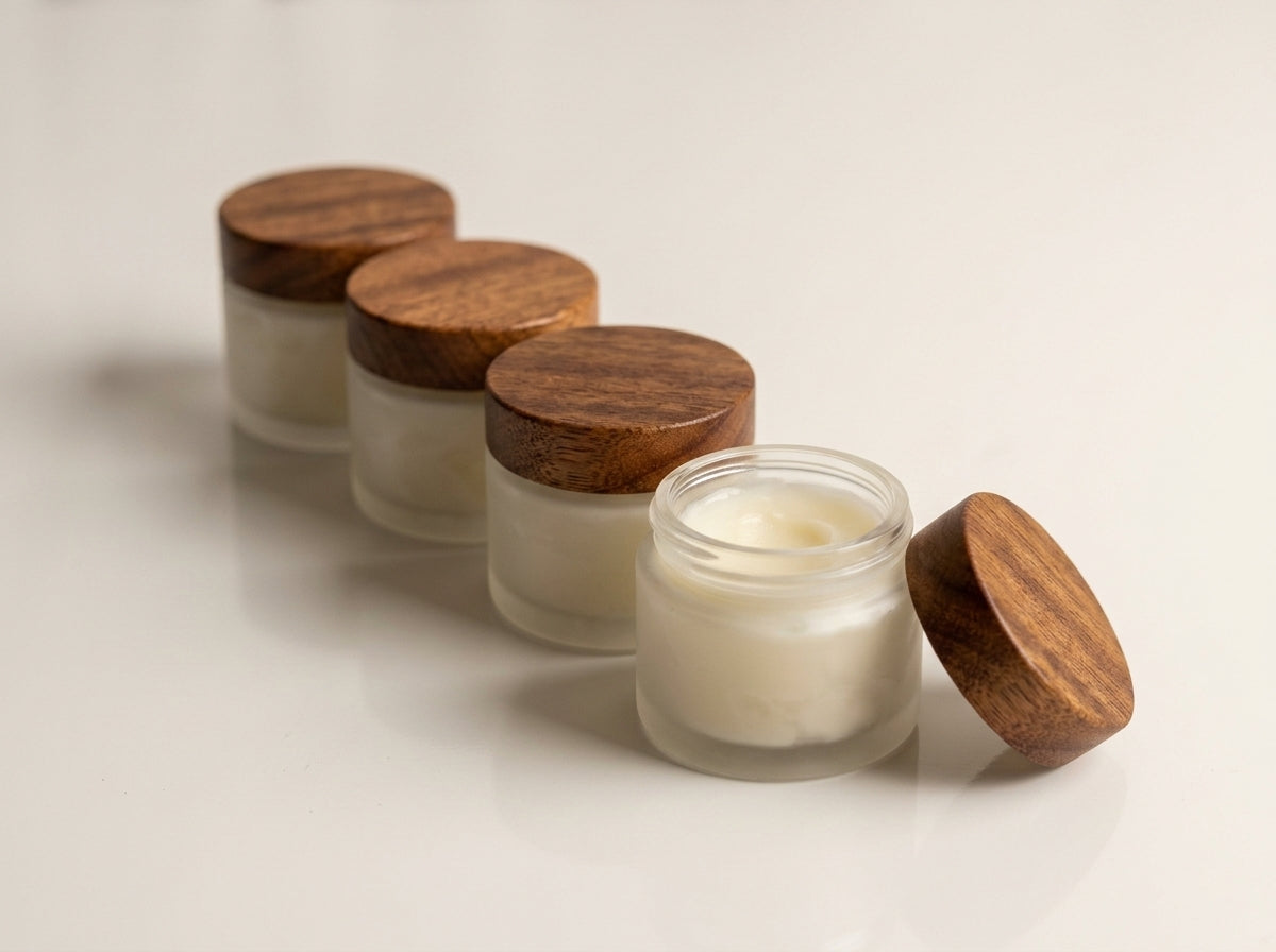 Four jars of Board Butter lined up on neutral studio surface