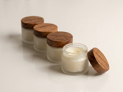 Four jars of Board Butter lined up on neutral studio surface