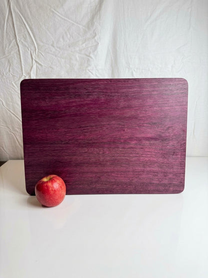 Purple Heart Cutting Board — Large 12x17 Standing with Apple for Scale
