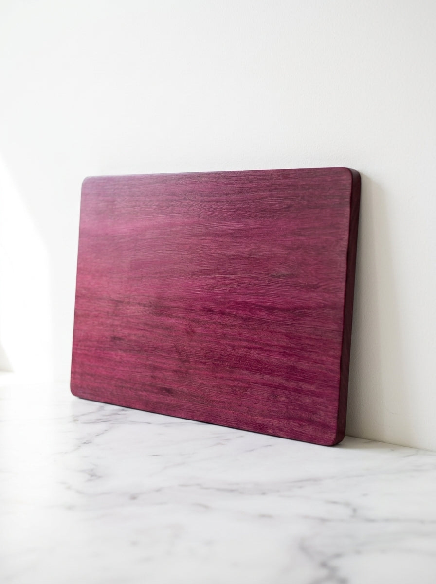 Purple heart cutting board leaning on marble counter