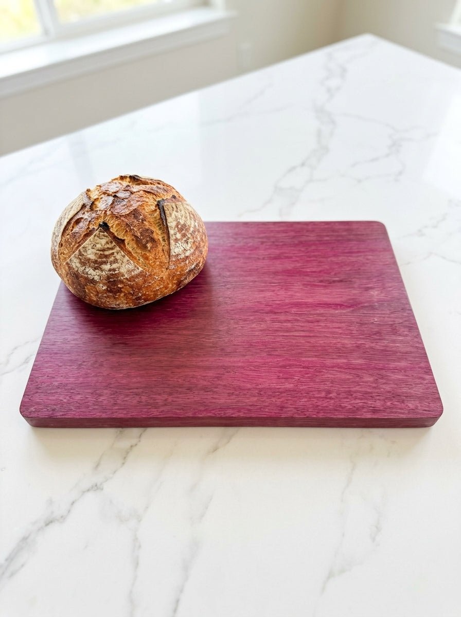 Purple heart cutting board with sourdough boule