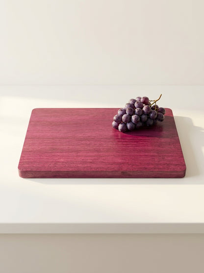 Purple heart cutting board with fresh grapes