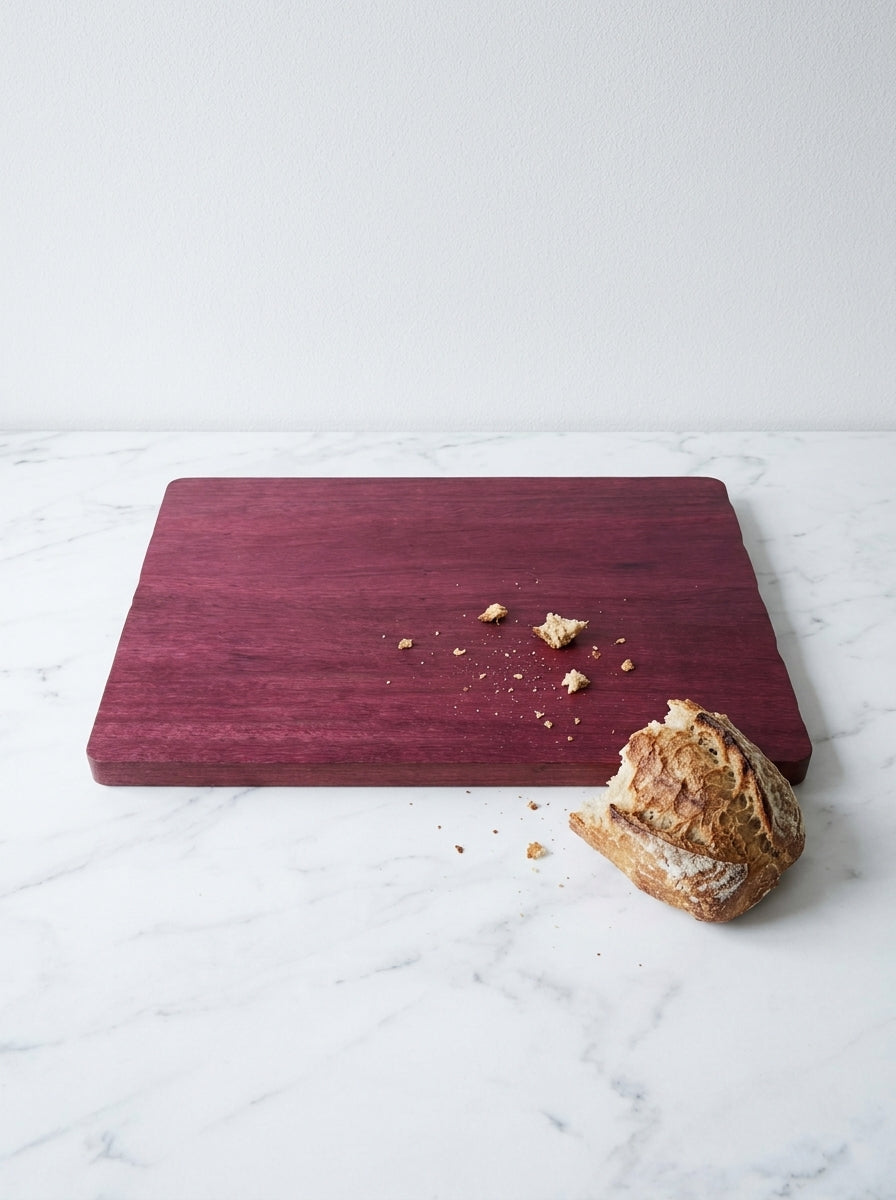 Purple heart cutting board with sourdough bread crumbs