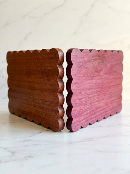 Purpleheart and sapele scalloped serving boards side by side showing exotic wood color options