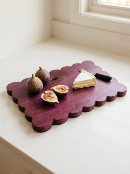 Handmade purpleheart scalloped serving board with halved figs, brie wedge, and cheese knife