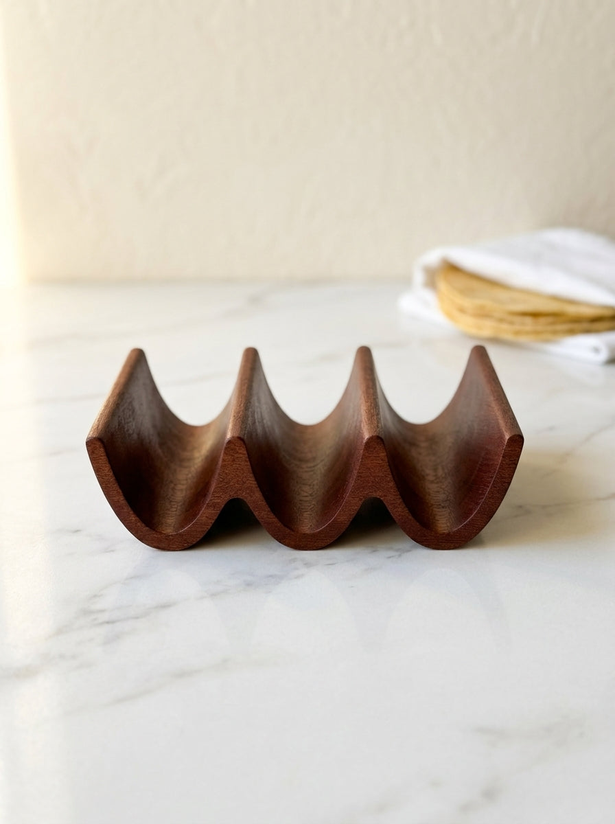 Handcrafted solid mahogany triple taco holder, side profile with three carved taco slots on marble