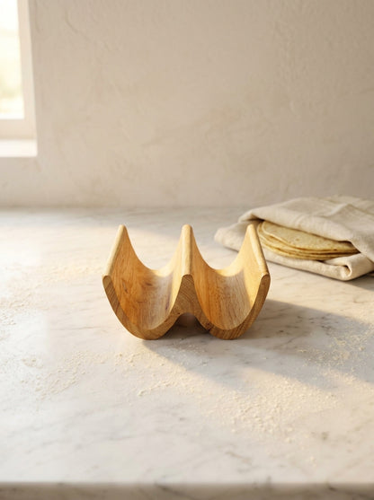 Handmade solid oak double taco holder, side profile showing two carved slots on white marble surface