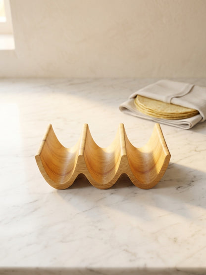 Handmade solid oak triple taco holder, side profile showing three carved slots on white marble counter
