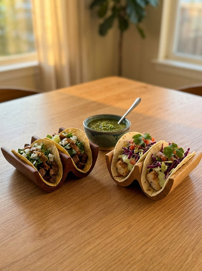 Two solid wood taco holders at a full taco night dinner spread, perfect for Taco Tuesday hosting
